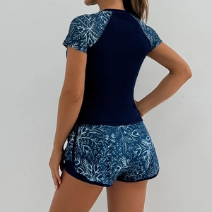Close-up back view of two-piece floral print tankini swimwear for women in deep blue