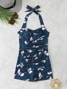 Flat lay of floral one-piece swimsuit with high elasticity and elegant beach vacation accessories