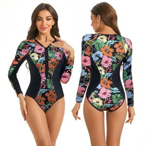 Close-up of long sleeve one-piece swimsuit featuring tropical floral prints and zipper neck