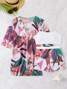 Flat lay of three-piece floral bikini set with white top and matching sheer cover-up