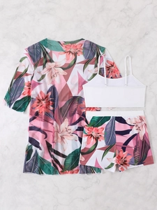 Flat lay of a three-piece floral bikini set including a white top and mesh cardigan