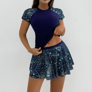 Two-piece short sleeve surf swimsuit with dark blue top and green floral skirt set