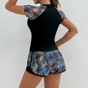 Rear view of women's two-piece tankini set featuring abstract geometric stripe prints