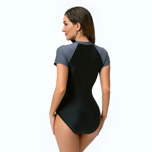 Detail shot of a one-piece women's short sleeve swimsuit with contrast side panels