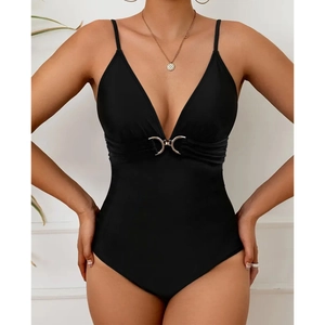 Close-up of black one-piece swimsuit featuring slim straps and a gold metal ring buckle