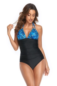 Detail of modest halter one-piece swimsuit with blue leopard print and ruched belly control