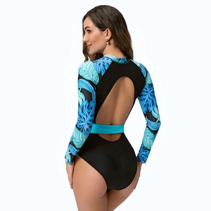 Detail of long sleeve swimsuit with tropical leaf print sleeves and an open back cutout
