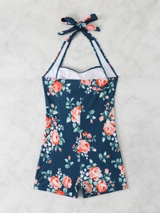 Deep blue halter one-piece swimsuit with rose floral print on a marble background