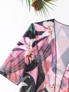 Pink floral mesh cover-up featuring vibrant lily patterns and loose long sleeves