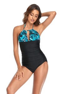 Detailed view of the halter neck and keyhole cutout with tropical print and ruching