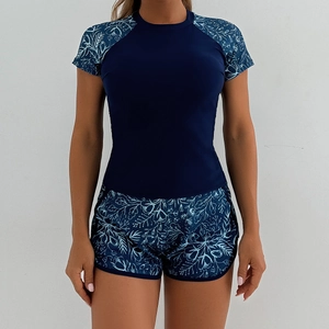 Women's two-piece floral tankini swim set with short sleeves and athletic shorts