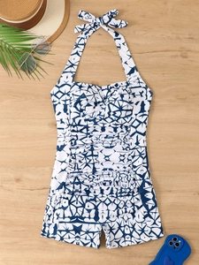 Flat lay of blue star print one-piece swimsuit with halter neck and ruching detail