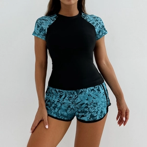 Women's two-piece sporty tankini swimsuit featuring black top and floral raglan sleeves
