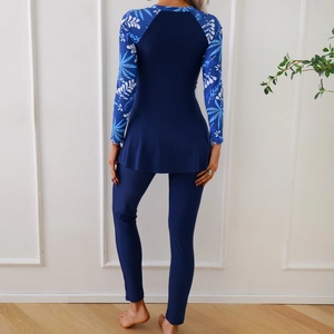Rear view of modest two-piece navy swimwear with tropical leaf print and skirted hem