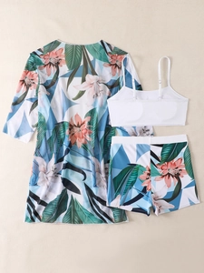 Detailed flat lay of three-piece bikini set with tropical floral print and sheer cover-up