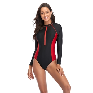 Detail of slim-fit long sleeve swimsuit featuring front zipper and red side patchwork