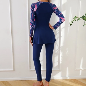 Rear view of modest two-piece swimwear with tropical floral print on long sleeves