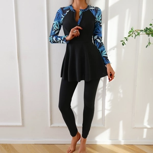 Detail of long sleeve modest swimsuit with tropical palm leaf print and front zipper closure