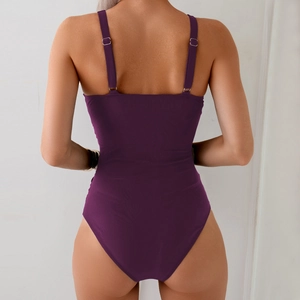 Detail of deep purple ribbed swimsuit with adjustable straps and open back design