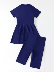 Detail of navy blue two-piece modest swimwear featuring a short sleeve top and shorts