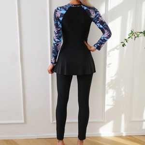 Rear view of modest burkini swimwear featuring blue leaf print top and black leggings