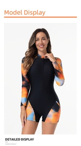 Detail view of long-sleeve swimsuit featuring orange blue gradient patterns and front zipper