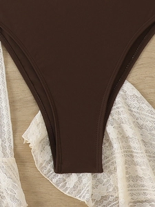 Detailed close-up of dark brown swimwear fabric with durable double-stitched hem and texture