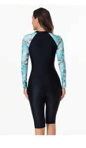 Rear view of long sleeve rash guard with tropical floral print and athletic cut