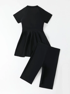 Flat lay of black two-piece modest swimwear featuring a short-sleeve top and leggings