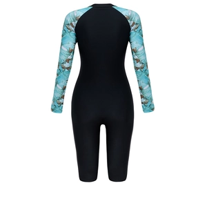 Rear view of long sleeve one piece swimsuit with tropical leaf print and black panels