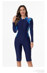 Detail of long-sleeved one-piece swimsuit with tropical floral prints and front zipper