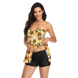 Detail of two-piece tankini set featuring sunflower print top and black swim shorts