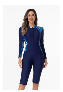 Close-up of long sleeve floral print surfing suit with front zipper and navy fabric