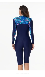 Back view of long-sleeve one-piece swimsuit featuring tropical floral prints and navy blue fabric