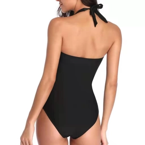 Detail of a black backless halter swimsuit featuring a slim fit and elastic nylon fabric
