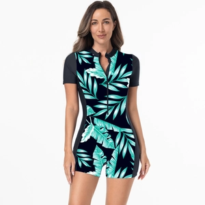 Front detail of women's short sleeve surfing swimsuit featuring green tropical leaf prints