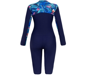 Rear view of long sleeve surf suit featuring navy fabric and tropical floral print details