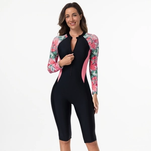 Close-up of women's long sleeve surf swimsuit featuring pink side panels and floral print sleeves