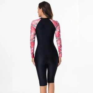 Rear view of long sleeve one piece surfing swimsuit with red tropical leaf print on sleeves