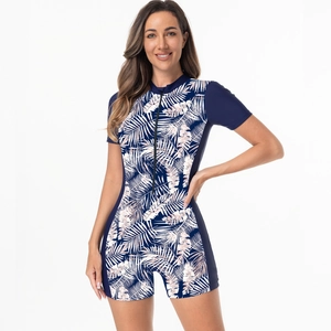 Detailed close-up of short-sleeved diving swimsuit featuring tropical palm leaf prints