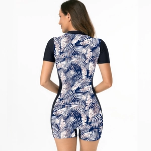Rear view of short sleeve one piece swimsuit with tropical plant print and black side panels
