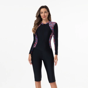 Detailed view of the front zipper and geometric pattern on the long sleeve swimsuit