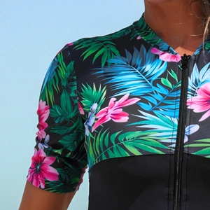 Detail of tropical floral print and front zipper closure on short sleeve rash guard