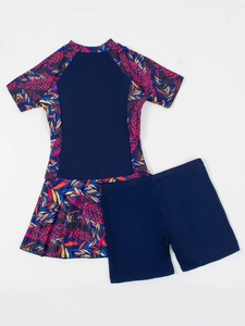 Flat lay detail of women's two-piece leaf print surf suit with short sleeves and shorts