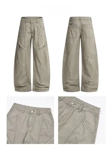 Détails du pantalon cargo large gris-vert avec coutures contrastées et sangles réglables
