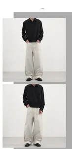 Détail de la coupe ample et du drapé du pantalon large gris sur un mannequin homme
