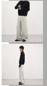 Détail du pantalon cargo gris ample avec une veste noire à boutons pour hommes