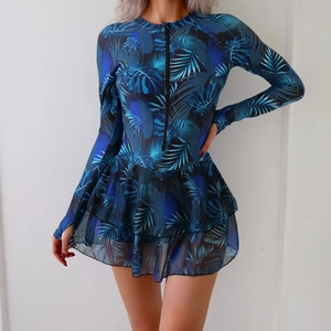 Detail of tropical palm print long sleeve swimsuit with zipper and mesh skirt