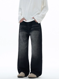 Men's loose black washed jeans with vintage whiskered texture and retro distressed style