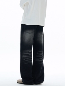 Men's loose vintage washed black denim jeans with retro whiskers and street style finish